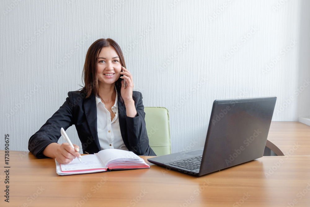 busy secretary is answering call and writing memo at the same time busy secretary is answering call and writing memo at the same time