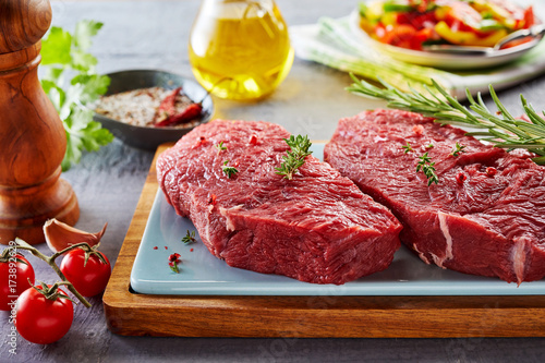 Raw rump steak prepared on cutting board