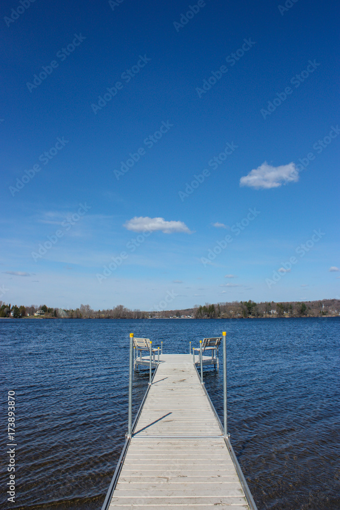 dock on a lake on blue sky
