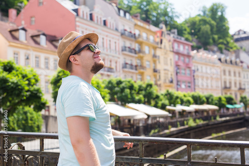 Young handsome man in old european town. Traveler, summer, people and journey concept © satura_