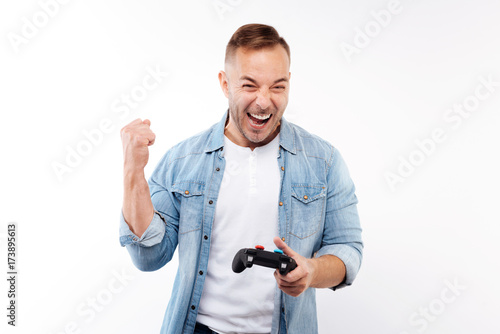 Happy man celebrating victory in video game