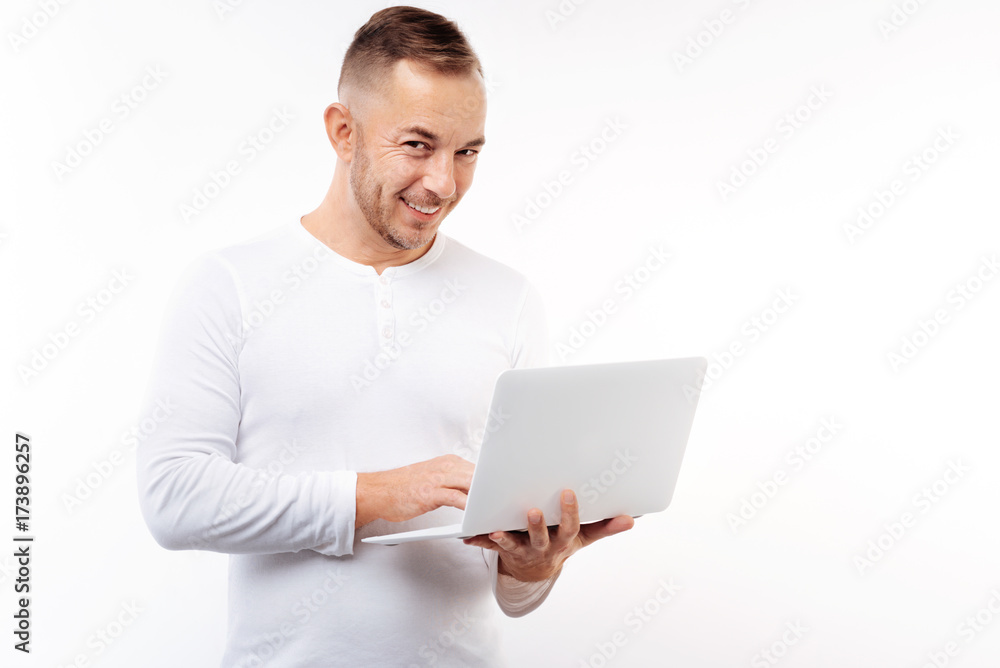 Handsome young man typing on laptop