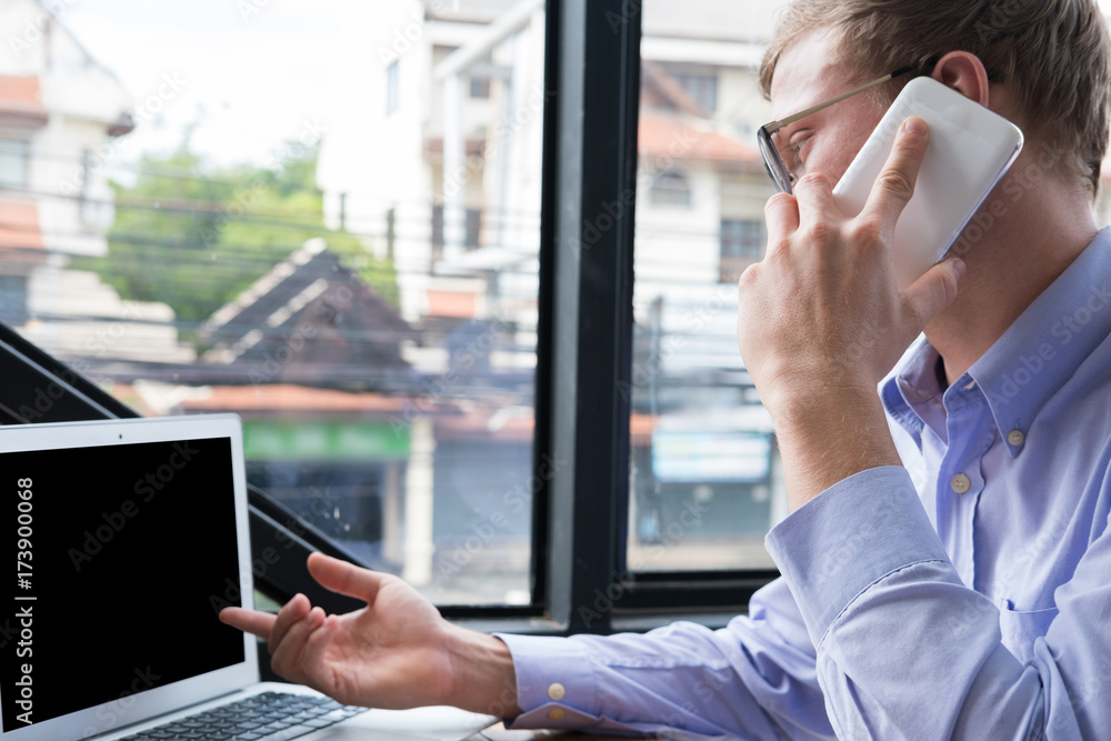 businessman talk on mobile phone at office. young man call on smart phone at workplace. employee use cellphone at work. business communication, lifestyle concept businessman talk on mobile phone at office. young man call on smart phone at workplace. employee use cellphone at work. business communication, lifestyle concept