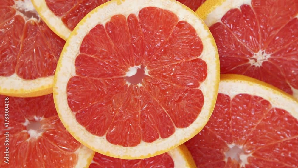 Abstract red background with citrus-fruit of grapefruit slices. Close-up. Abstract red background with citrus-fruit of grapefruit slices. Close-up.