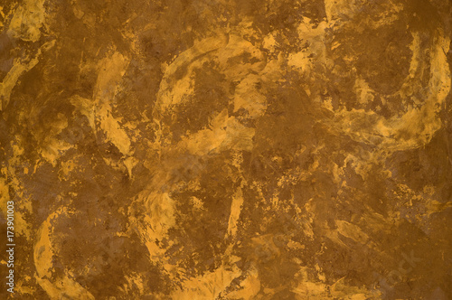 background of the plastered texture with marble effect gold color. artistic background handmade
