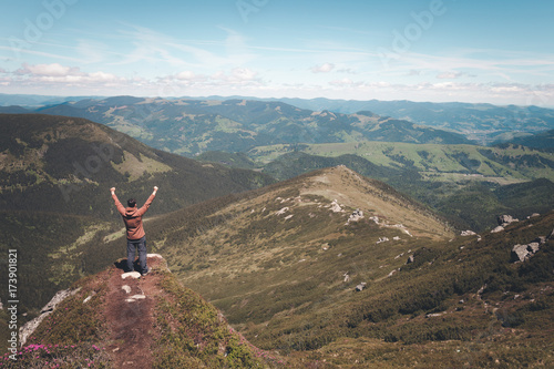 Man standing on the mountain top and looking at horizon © Nickolay Khoroshkov