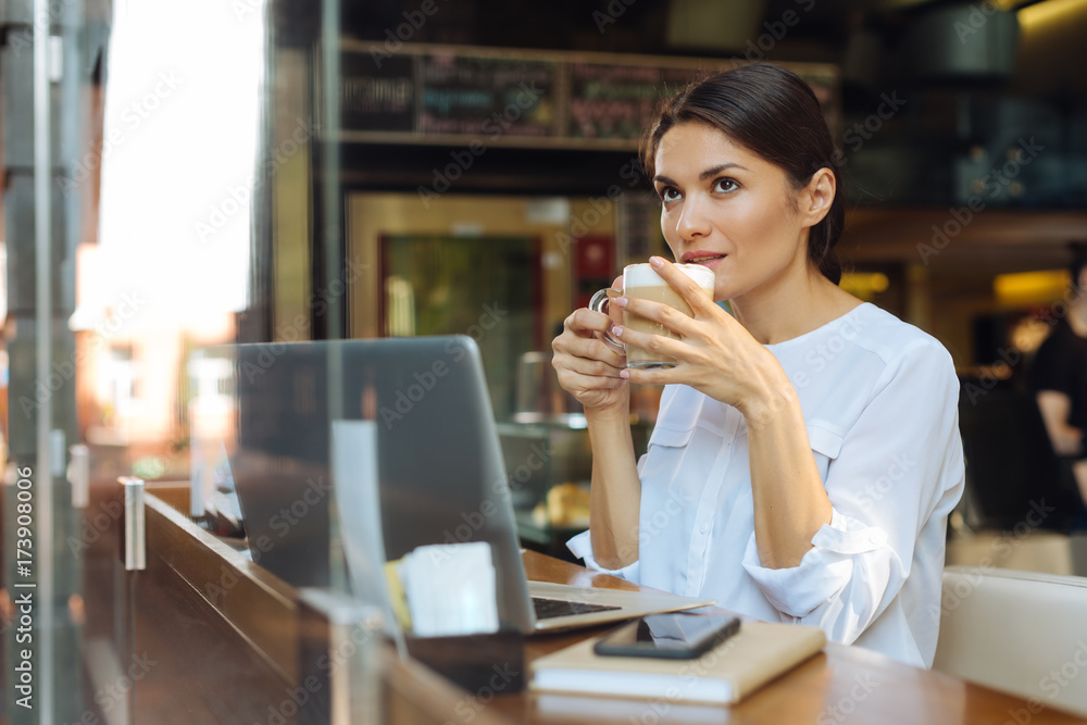 Pretty businesswoman drinking latte in cafe Pretty businesswoman drinking latte in cafe