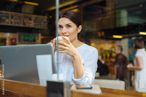 Pretty woman enjoying latte at cafe counter © Viacheslav Yakobchuk