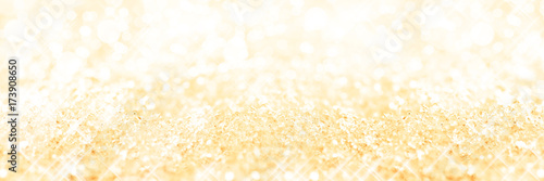 Panoramic golden background of snow, holiday glittering background