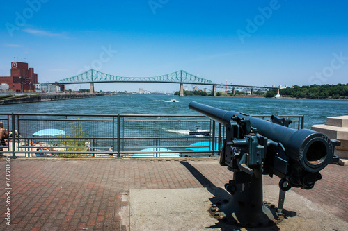 old gun pointing at the Jacques-Cartier bridge in old Montreal, Quebec, Canada