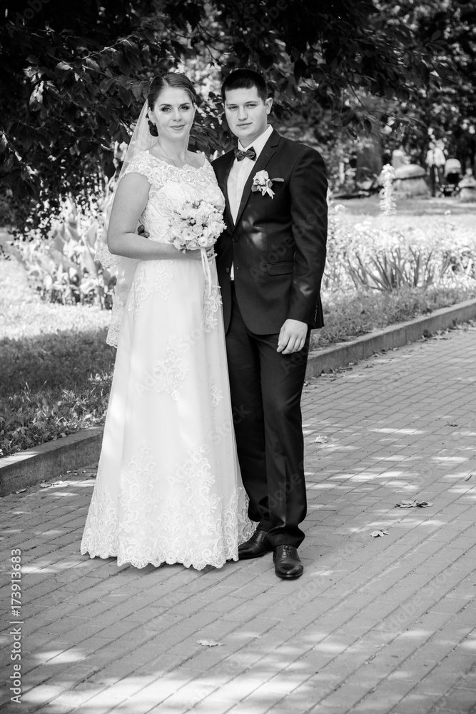 Wedding on a warm, sunny day in a beautiful European park. The groom is younger than the bride.Plus size woman- bride . A nice and beautiful couple have a happy day Wedding on a warm, sunny day in a beautiful European park. The groom is younger than the bride.Plus size woman- bride . A nice and beautiful couple have a happy day