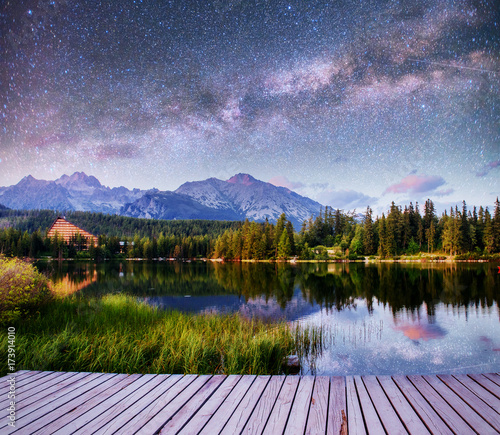 Fantastic starry sky and the milky way over a lake in the park High Tatras. Shtrbske Pleso, Slovakia, Europe