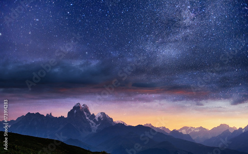 Fantastic starry sky. Autumn landscape and snow-capped peaks. Main Caucasian Ridge. Mountain View from Mount Ushba Meyer, Georgia. Europe photo