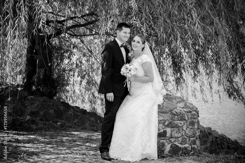 Wedding on a warm, sunny day in a beautiful European park. The groom is younger than the bride.Plus size woman- bride . A nice and beautiful couple have a happy day Wedding on a warm, sunny day in a beautiful European park. The groom is younger than the bride.Plus size woman- bride . A nice and beautiful couple have a happy day
