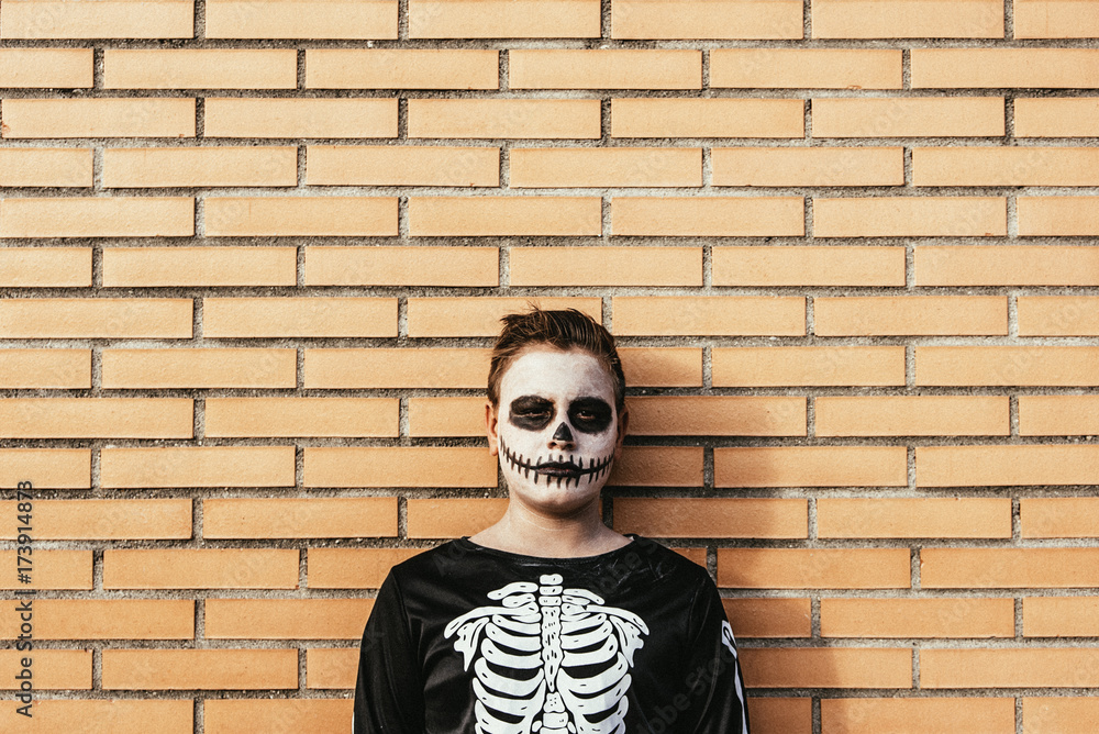 Portrait of boy disguised of skeleton in the street. Portrait of boy disguised of skeleton in the street.