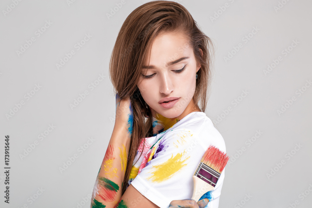 young woman smeared in multicolored paint. young woman smeared in multicolored paint.
