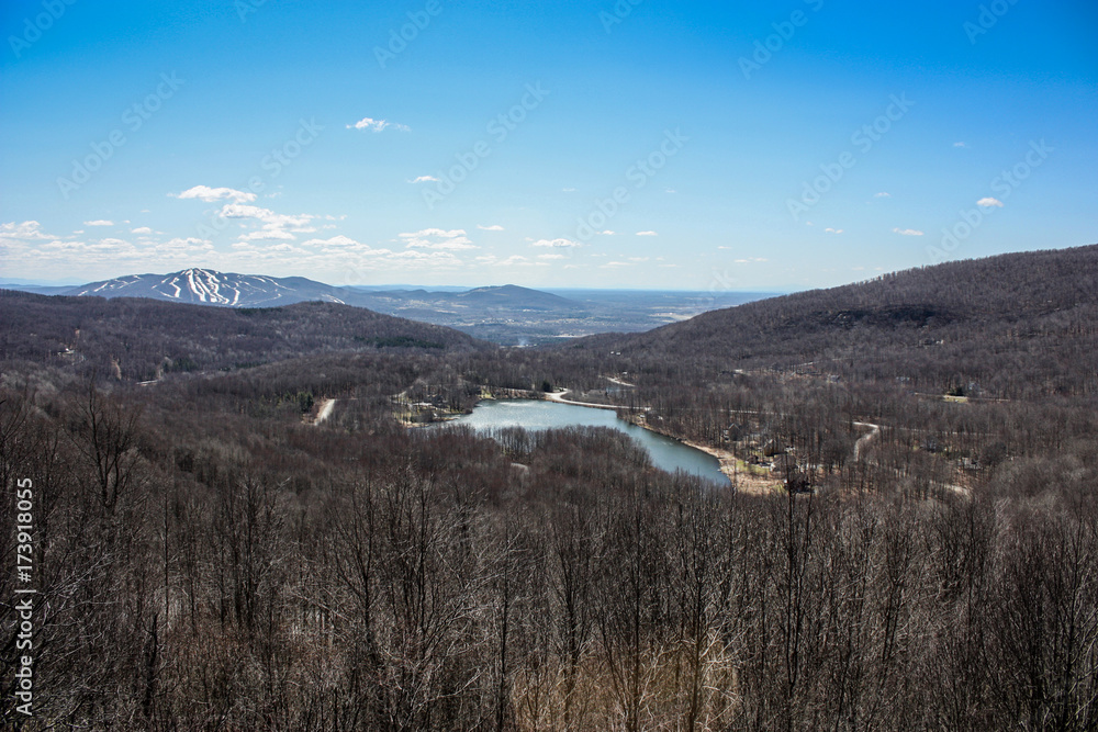 view of a lake and ski slopes from the top of a mountain