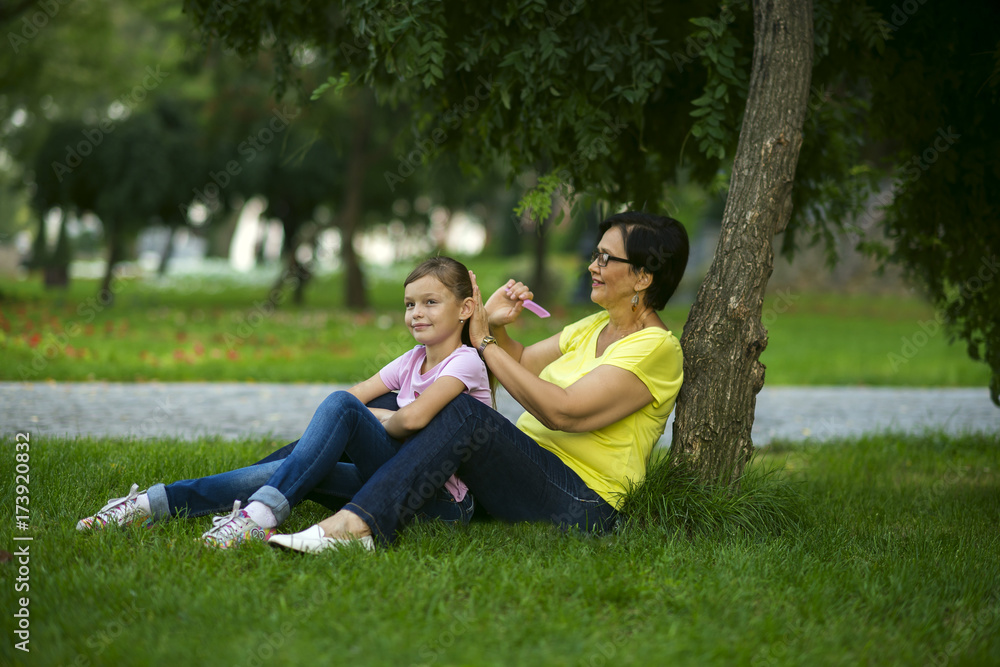Grandma is combing her granddaughter's hair Grandma is combing her granddaughter's hair