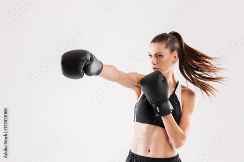 Portrait of a young motivated woman doing boxing © Drobot Dean