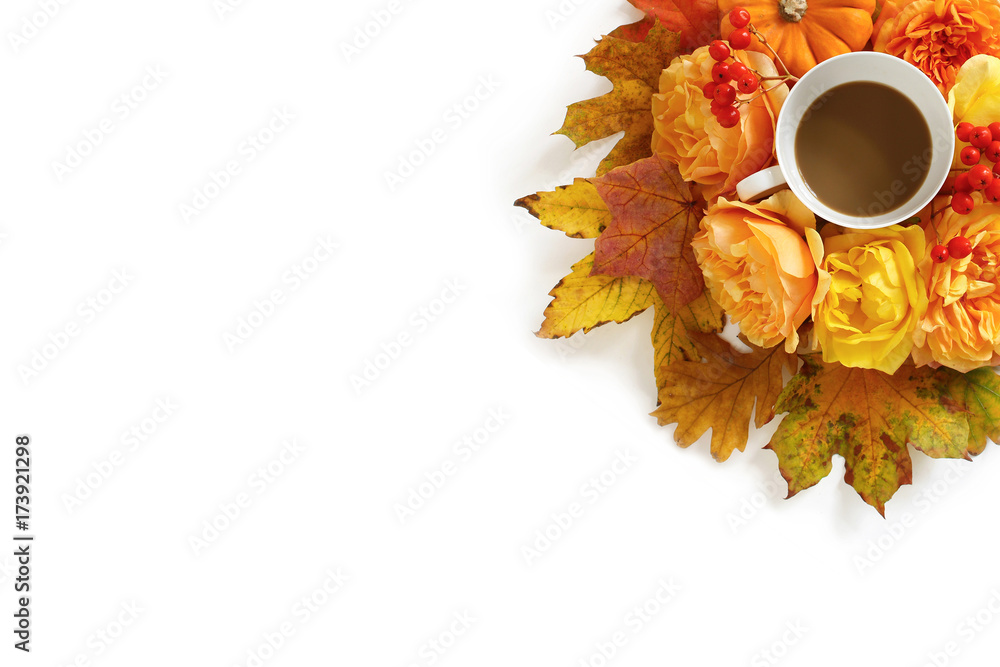 Styled stock photo.with cup of coffee and floral composition made of colorful autumn leaves, orange pumpkin, roses and rowan berries isolated on white background. Flat lay, top view.