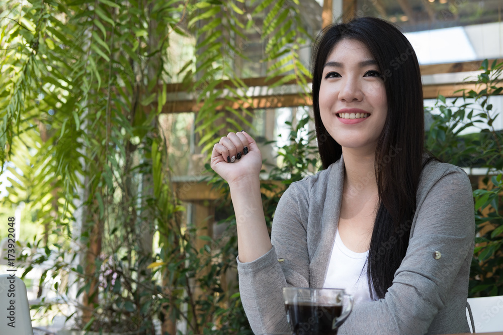 asian woman sit at outdoor cafe. young female adult with natural make-up relax at coffee shop. attractive teenager smile with happiness in garden asian woman sit at outdoor cafe. young female adult with natural make-up relax at coffee shop. attractive teenager smile with happiness in garden