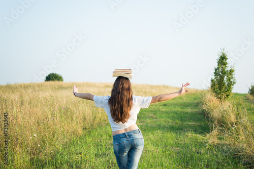 Wallpaper Mural Free girl with school books above head Torontodigital.ca