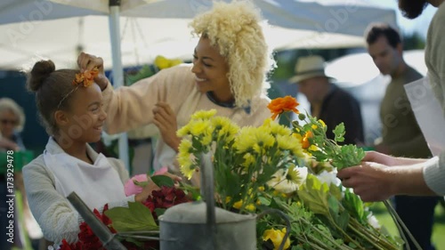  Mother & daughter working on a flower stall at the farmers market photo