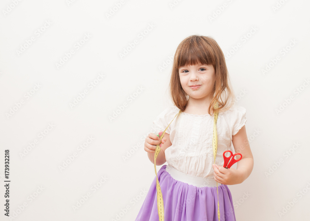 Girl with scissors, centimeter and sewing thread in the hands Girl with scissors, centimeter and sewing thread in the hands