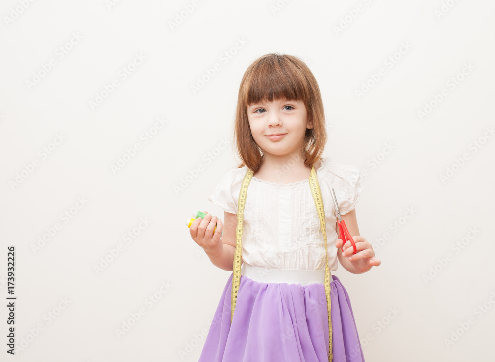 Girl with scissors, centimeter and sewing thread in the hands Girl with scissors, centimeter and sewing thread in the hands