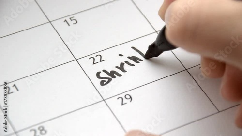 Writing SHRINK on calendar with a black marker