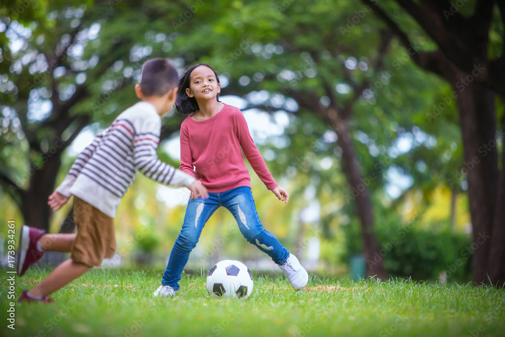 asian boy and girl enjoying with soccer game asian boy and girl enjoying with soccer game