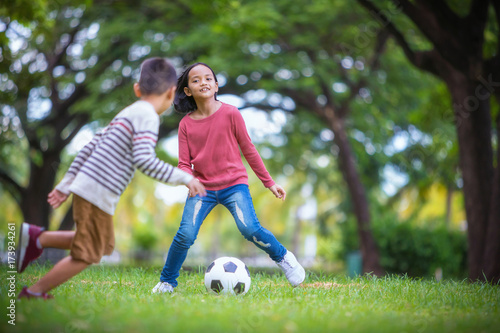 asian boy and girl enjoying with soccer game