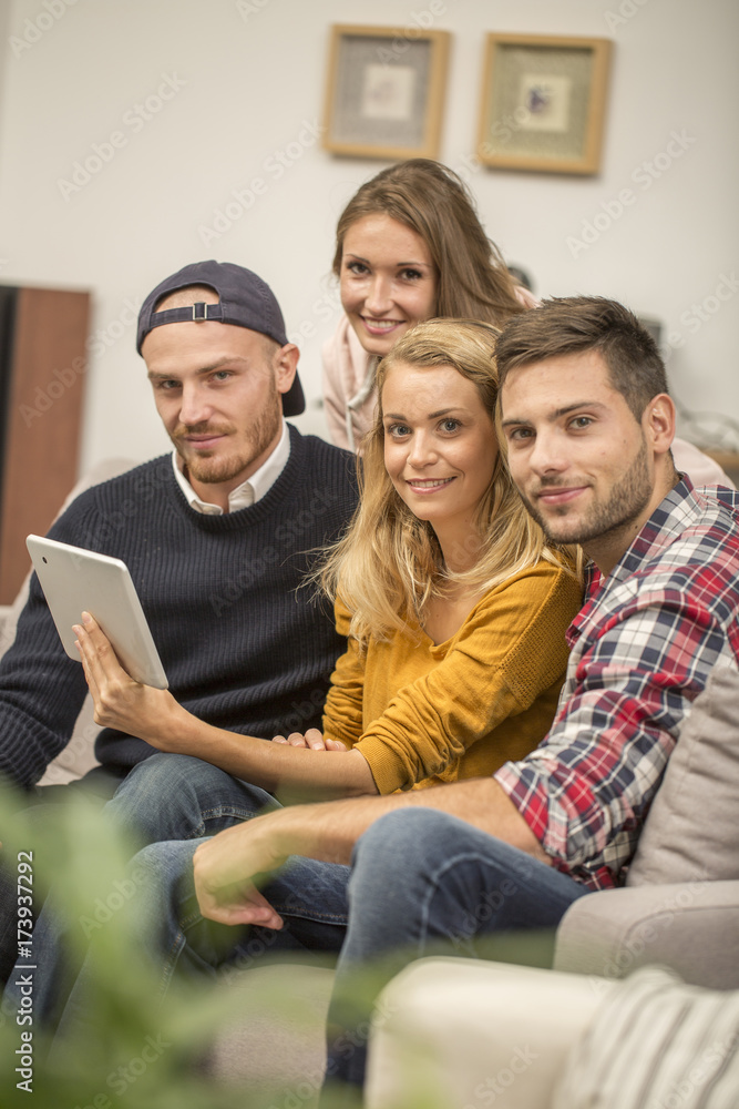 roommates choosing tv program on digital tablet roommates choosing tv program on digital tablet