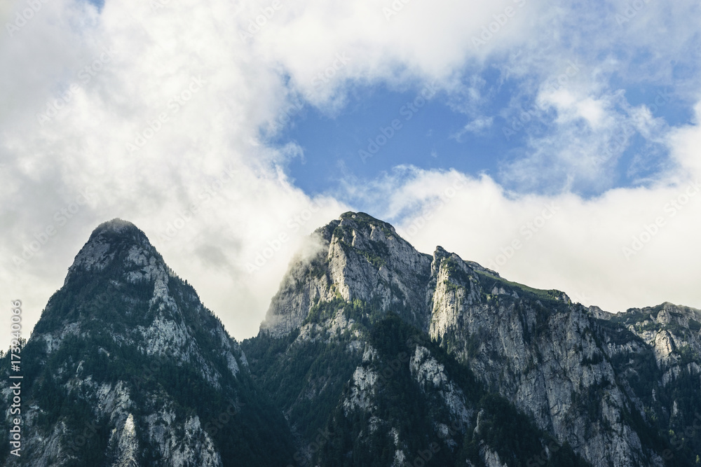 Low Angle View Of Bucegi Mountains Against Cloudy Sky Low Angle View Of Bucegi Mountains Against Cloudy Sky