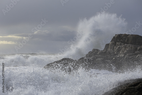 Big wave splash against cliff