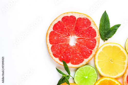 citrus food corner on white background - assorted citrus fruits with mint leaves. Isolated on white background © dashtik