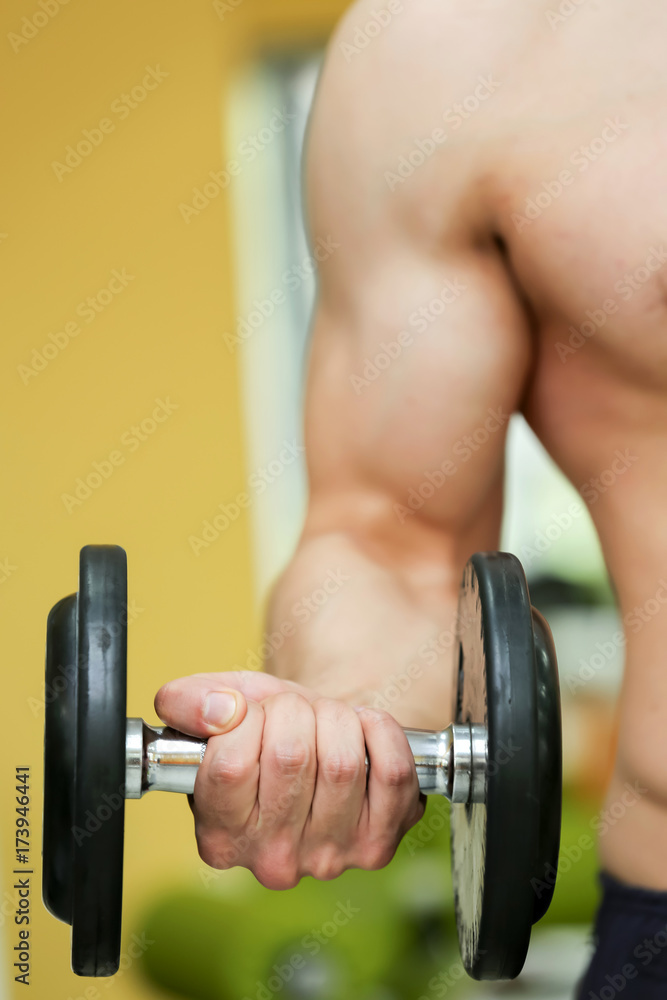 close up photo of bodybuilder man hand doing biceps exercise with dumbbell in fitness club close up photo of bodybuilder man hand doing biceps exercise with dumbbell in fitness club