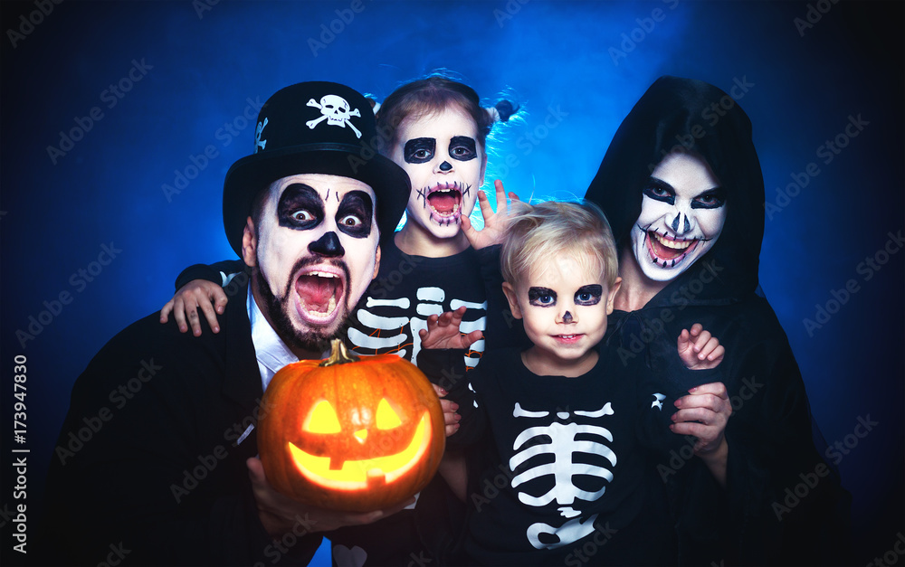 Fototapeta premium happy family mother father and children in costumes and makeup on Halloween