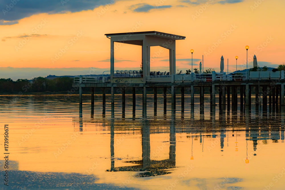 sunset over the transylvania lake in Umbria Italy intense late summer colors in the pier sunset over the transylvania lake in Umbria Italy intense late summer colors in the pier