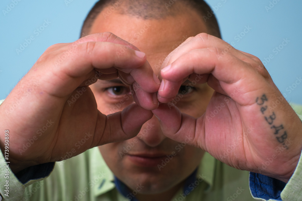 Fototapeta premium man looking through hands, making binoculars