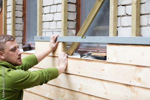 Bilde på lerret restoring old brick house exterior with new wooden planks