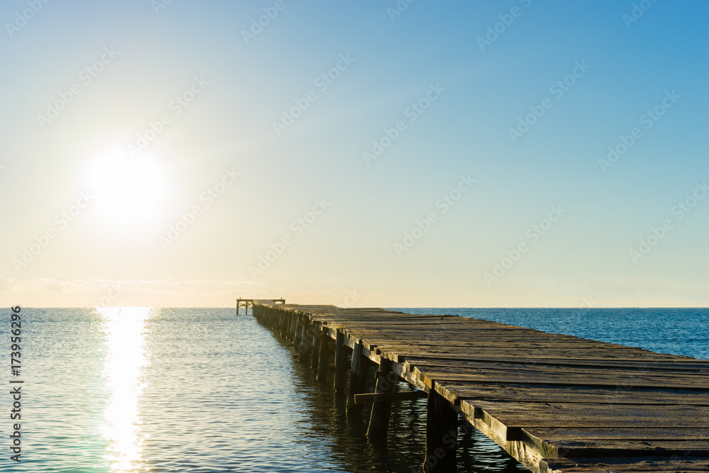 a wooden pier in the sun