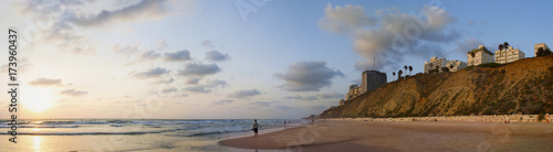 The man looks at the sunset on the sea coast
