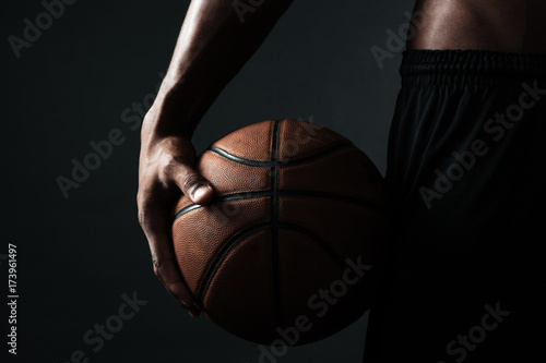 Cropped photo of basketball player holding ball © Drobot Dean