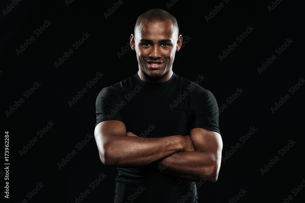Smiling afro american sports man with arms folded looking at camera