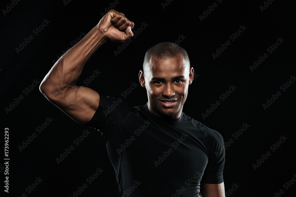 Young happy afro american sports man celebrating his victory with raised arm