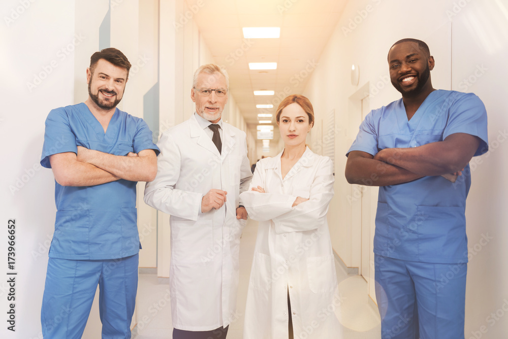 Group of professional medical workers looking straight on camera Group of professional medical workers looking straight on camera