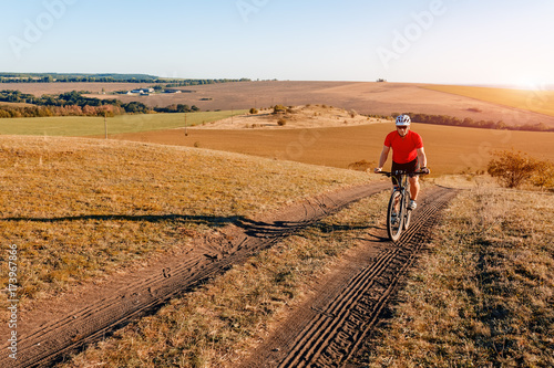 Traveler with backpack Riding the Bike on the Beautiful autumn