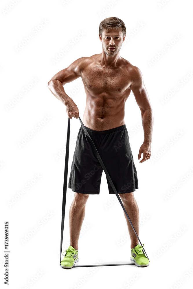 Handsome fitness man working out with rubber band, studio shot. Handsome fitness man working out with rubber band, studio shot.