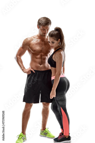 Young sportsmen couple woman and man in studio on white background